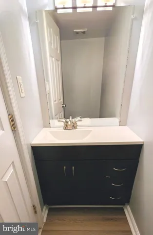 a bathroom with a sink vanity and mirror