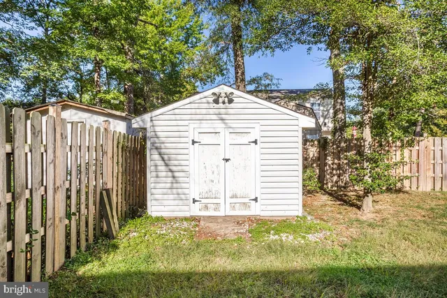 a view of a house with wooden fence