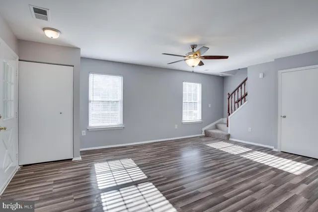 wooden floor in an empty room with a window