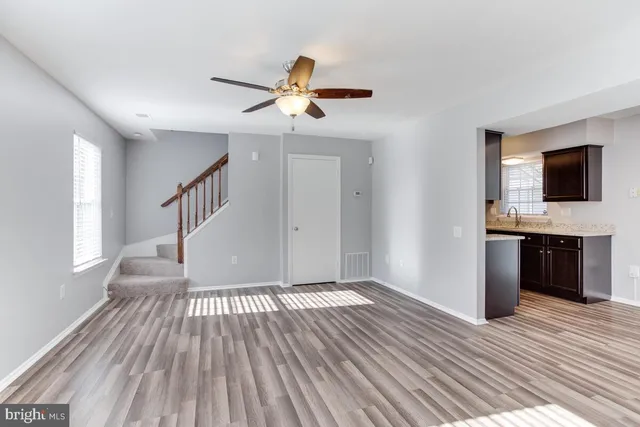a view of livingroom with hardwood floor and a ceiling fan