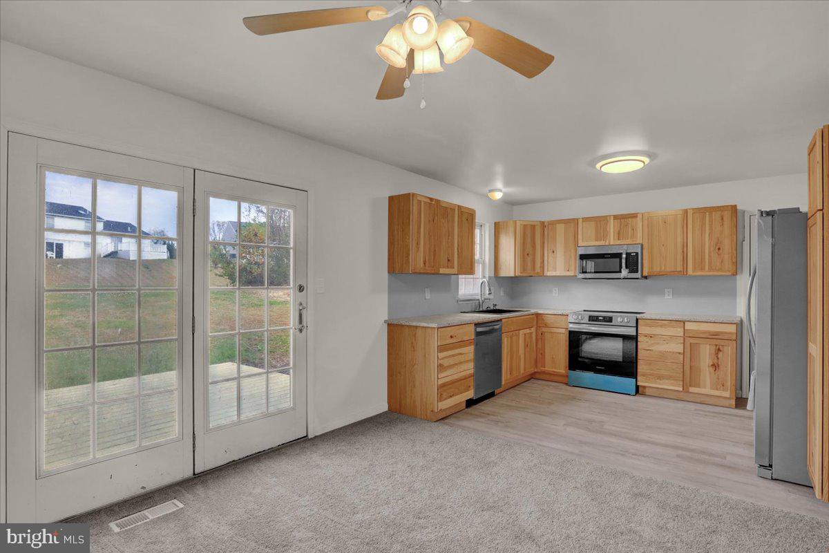 407 Groffdale Road Quarryville, PA 17566 - Photo 11 of 29 a large kitchen with a large window and stainless steel appliances