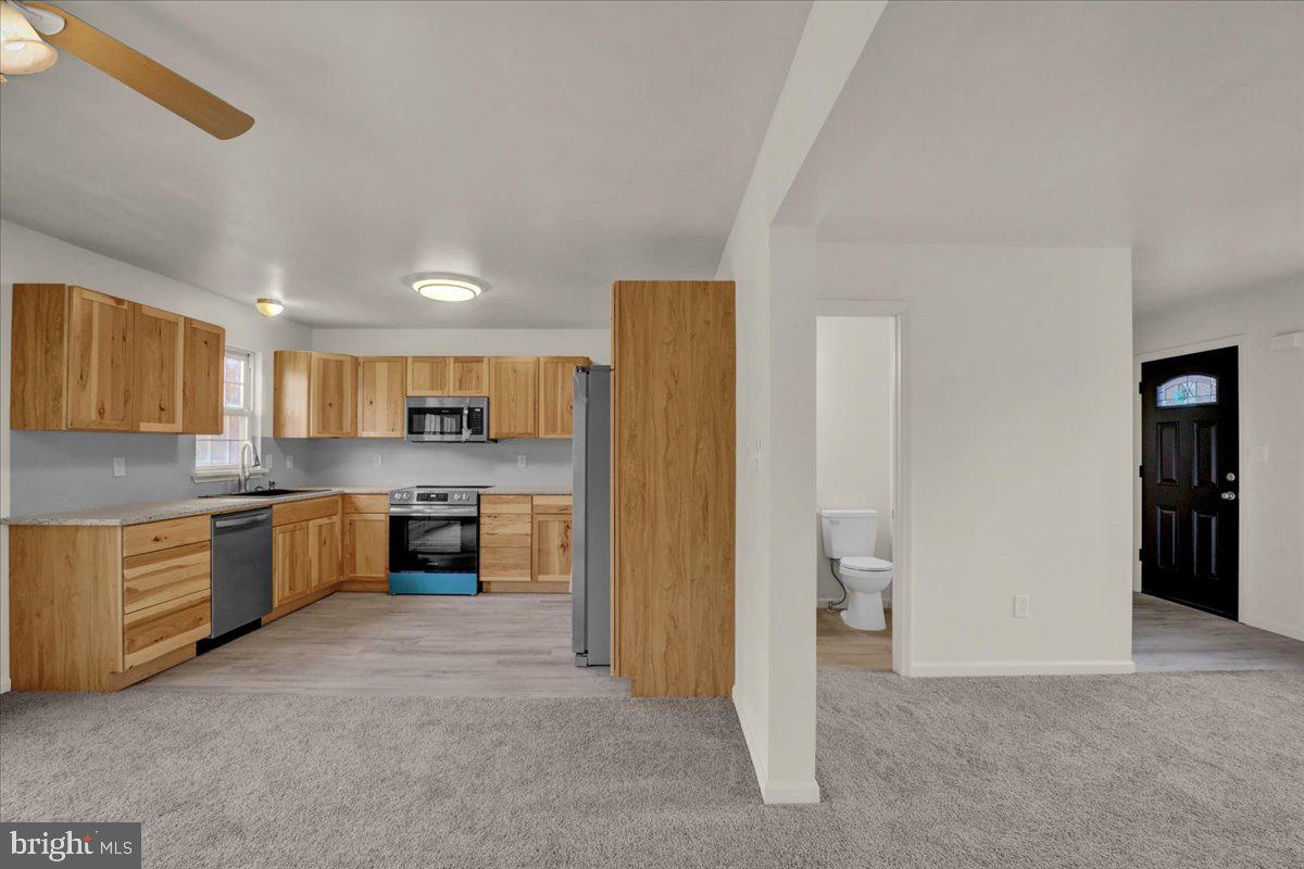 407 Groffdale Road Quarryville, PA 17566 - Photo 10 of 29 a large kitchen with a refrigerator and a stove top oven