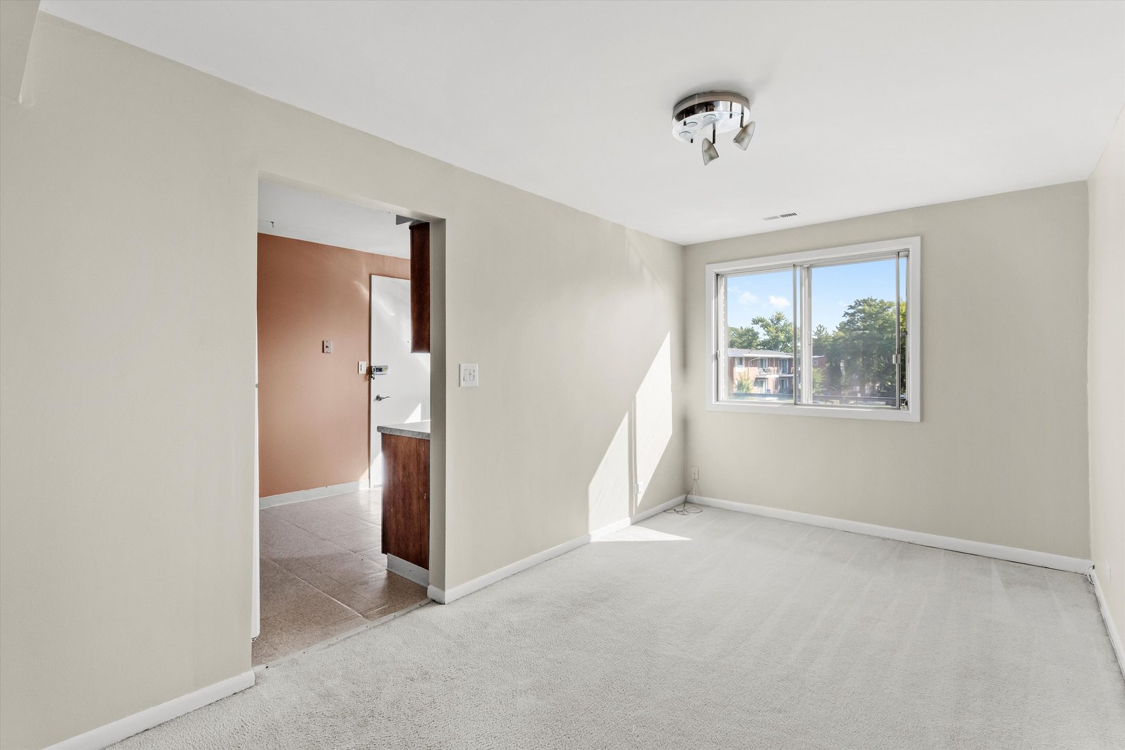 10124 Peach Parkway, Unit 208 Skokie, IL 60076 - Photo 11 of 38 a view of an empty room with a window