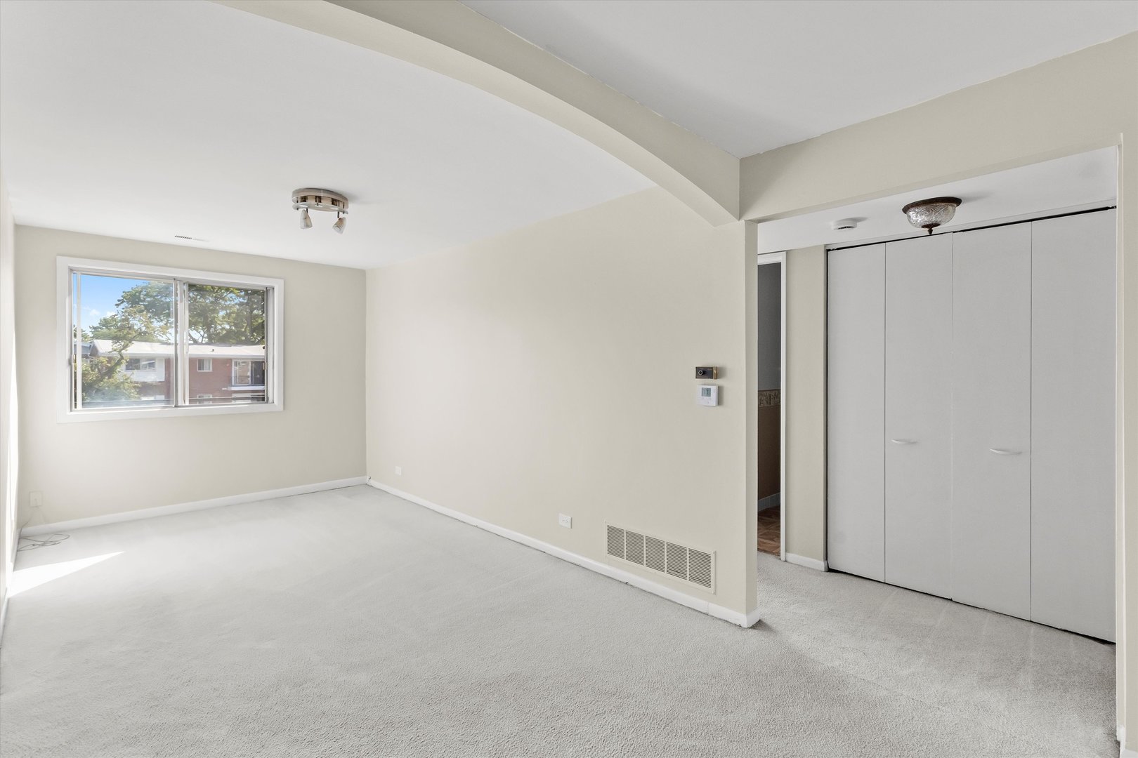 10124 Peach Parkway, Unit 208 Skokie, IL 60076 - Photo 12 of 38 a view of an empty room with windows and closet