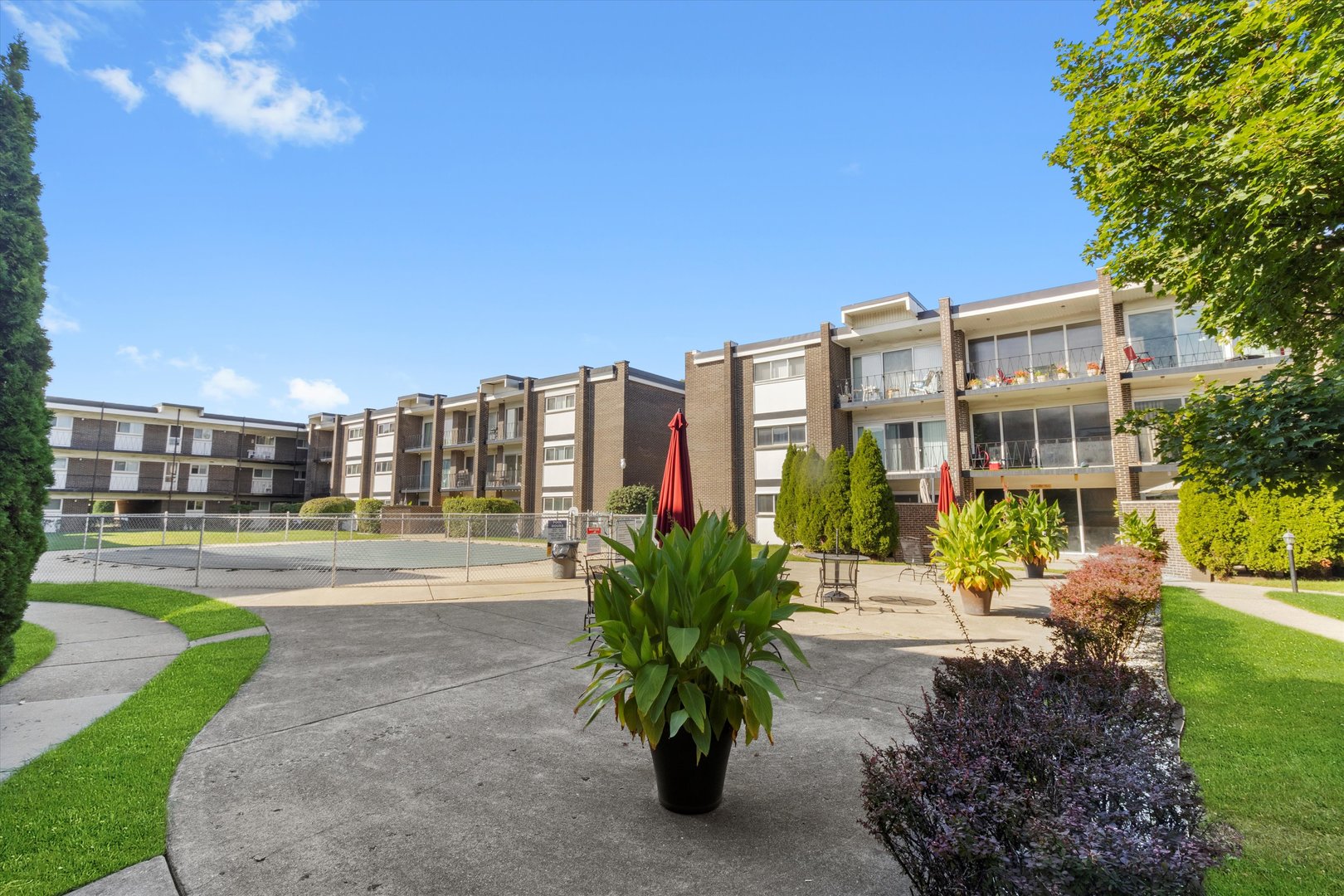 10124 Peach Parkway, Unit 208 Skokie, IL 60076 - Photo 4 of 38 a view of a building with a garden