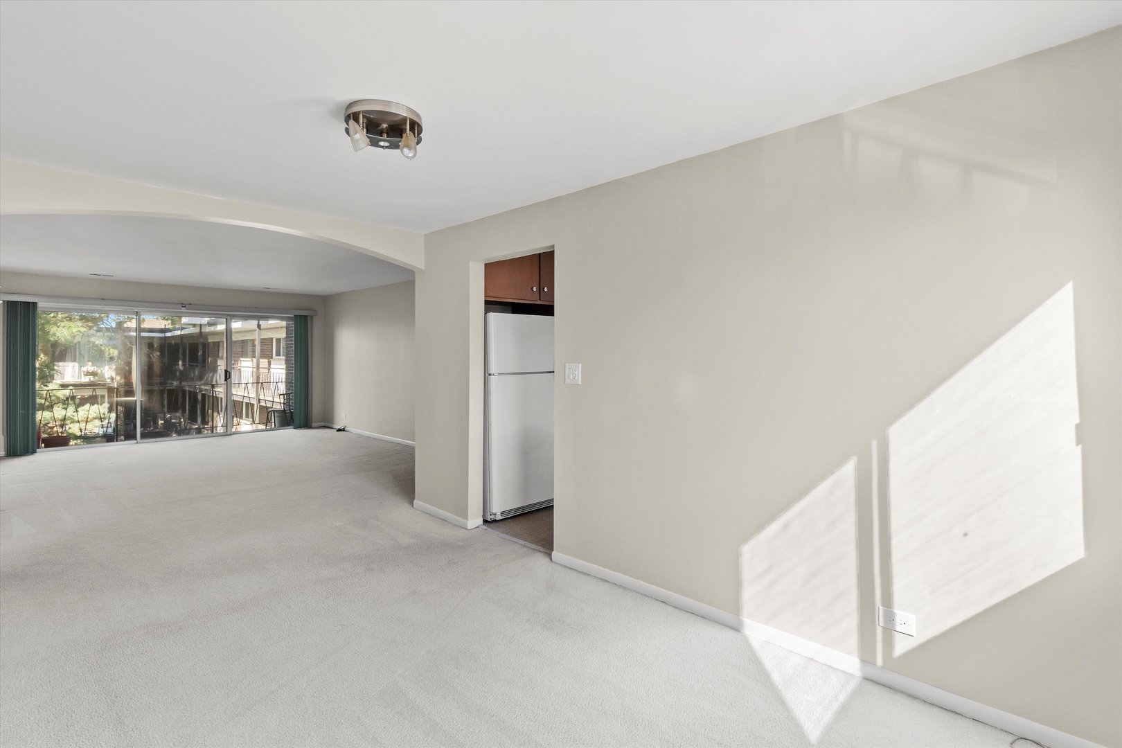 10124 Peach Parkway, Unit 208 Skokie, IL 60076 - Photo 7 of 38 a view of a livingroom with an empty space and window