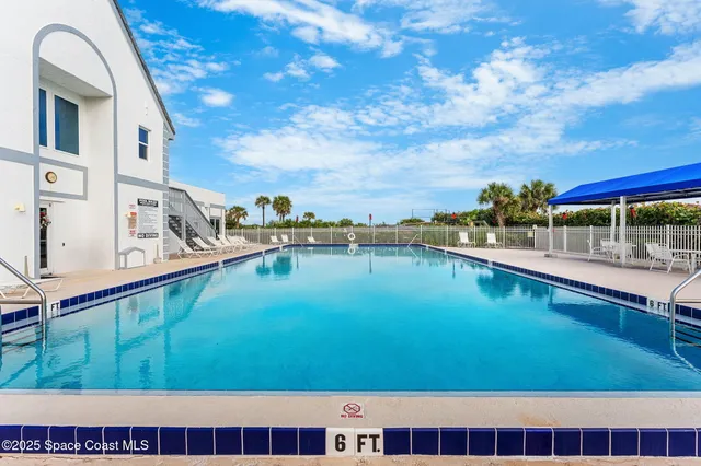 a view of a swimming pool with outdoor seating
