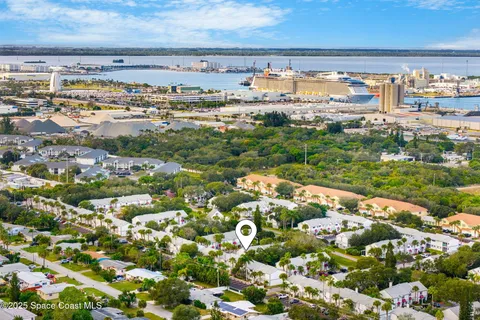 a view of open area with lots of green space and building in the background