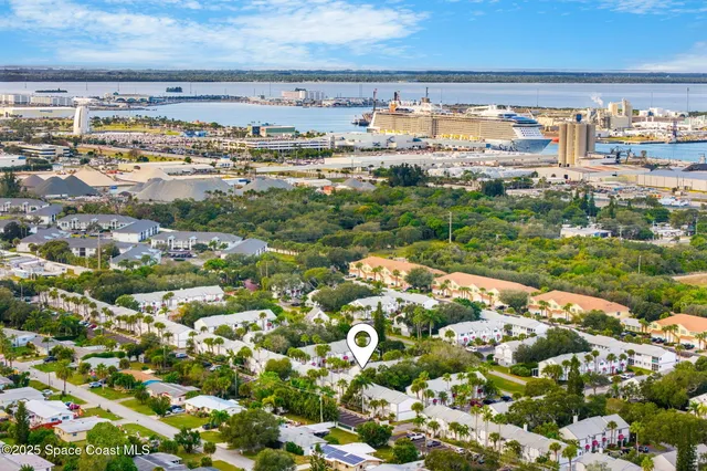 a view of open area with lots of green space and building in the background