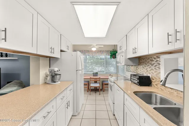 a kitchen with cabinets a sink and appliances