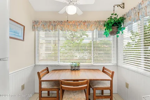 a table with chairs and a window
