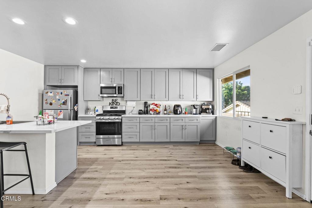 2730 Jill Place Port Hueneme, CA 93041 - Photo 5 of 25 a kitchen with white cabinets and white appliances