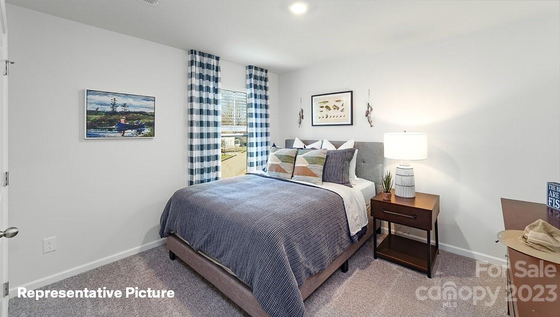 3791 Charles Street Northwest Conover, NC 28613 - Photo 23 of 32 a bedroom with a bed and a lamp on dresser