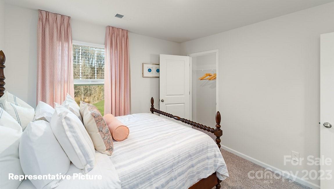 3791 Charles Street Northwest Conover, NC 28613 - Photo 26 of 32 a bedroom with a bed and a large window