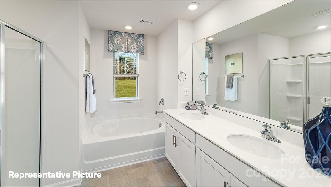 3791 Charles Street Northwest Conover, NC 28613 - Photo 27 of 32 a bathroom with a tub sink and mirror