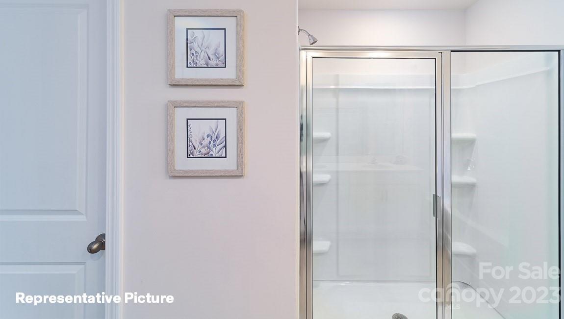 3791 Charles Street Northwest Conover, NC 28613 - Photo 29 of 32 a bathroom with a shower and a glass door