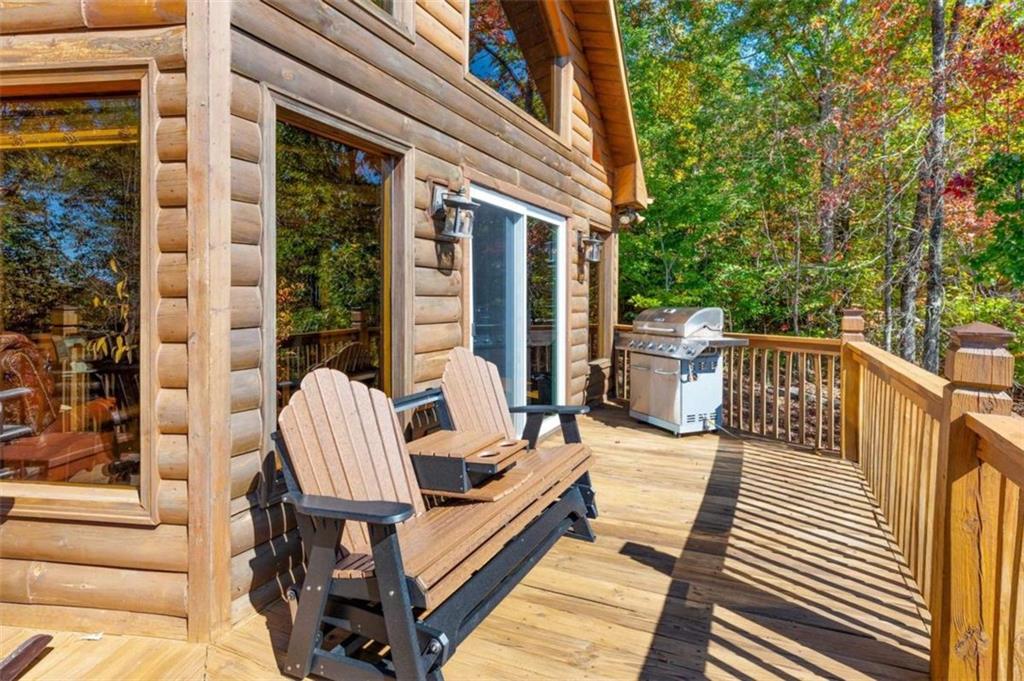 192 Oak Ridge Way Morganton, GA 30560 - Photo 14 of 56 a balcony with wooden floor and furniture