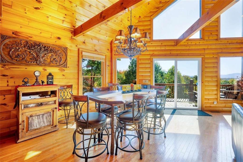 192 Oak Ridge Way Morganton, GA 30560 - Photo 30 of 56 a view of a patio with table and chairs with wooden floor and fence