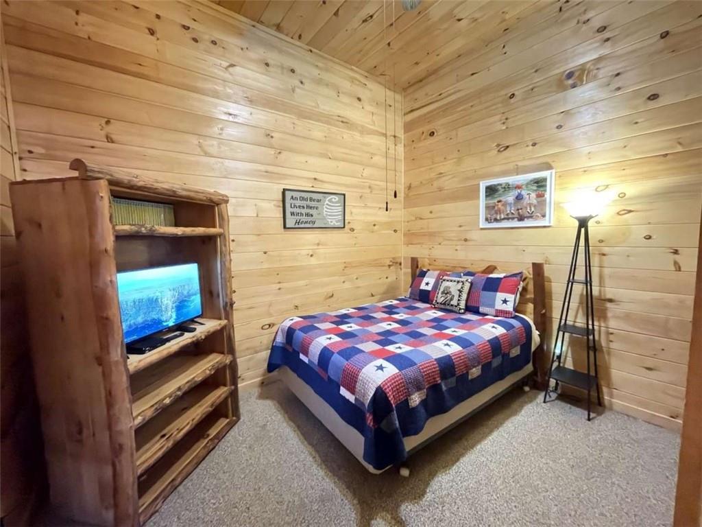 192 Oak Ridge Way Morganton, GA 30560 - Photo 39 of 56 a bedroom with a bed and a flat screen tv