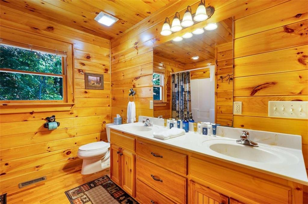 192 Oak Ridge Way Morganton, GA 30560 - Photo 40 of 56 a bathroom with a double vanity sink toilet and shower