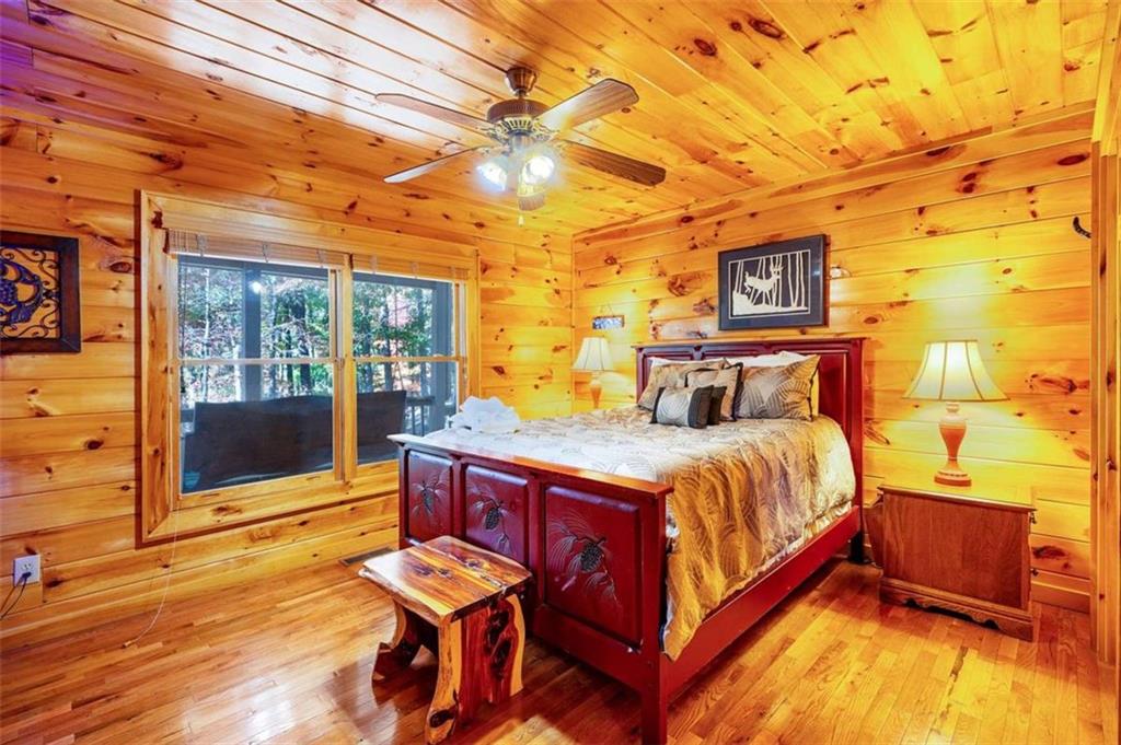 192 Oak Ridge Way Morganton, GA 30560 - Photo 50 of 56 a bedroom with a bed and wooden floor