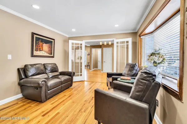 a living room with furniture and large windows