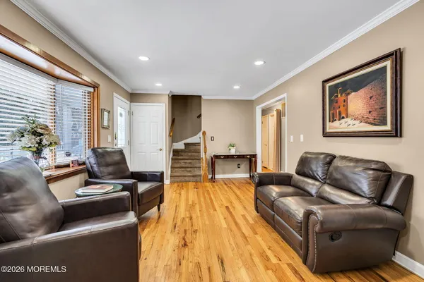 a view of kitchen with stainless steel appliances granite countertop a stove top oven a sink dishwasher a dining table and chairs with wooden floor