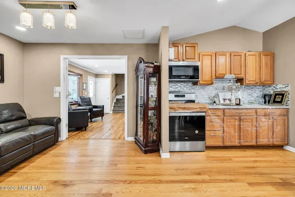 a view of a a dining room with furniture window and wooden floor