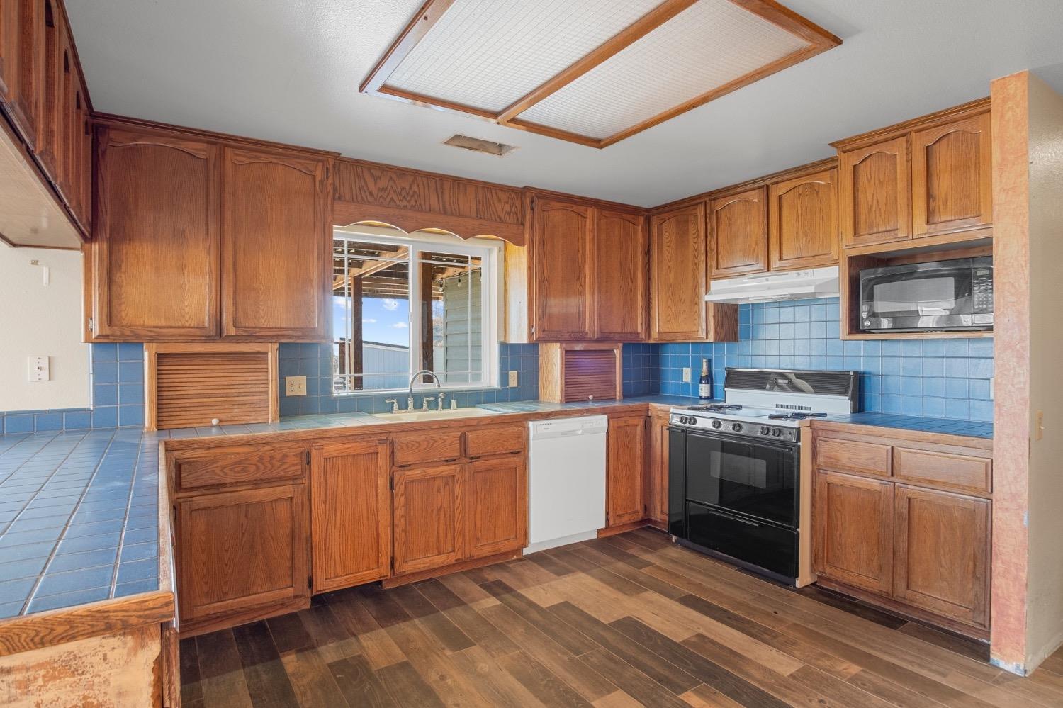 17164 Keyes Road Snelling, CA 95369 - Photo 26 of 51 a kitchen with stainless steel appliances granite countertop a stove sink and cabinets