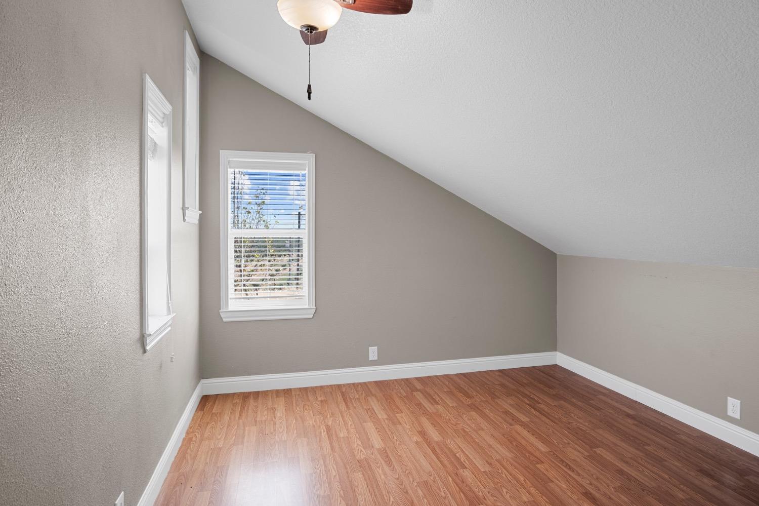 17164 Keyes Road Snelling, CA 95369 - Photo 28 of 51 an empty room with wooden floor cabinet and windows