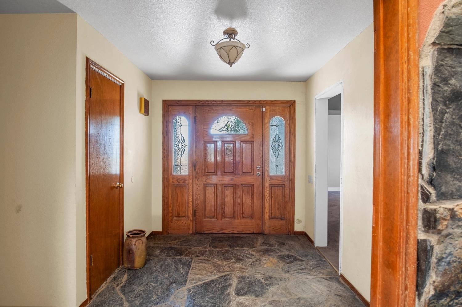 17164 Keyes Road Snelling, CA 95369 - Photo 8 of 51 a view of a hallway with wooden floor and a bathroom