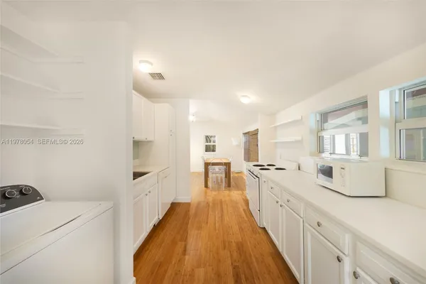 a kitchen with sink a stove and cabinets
