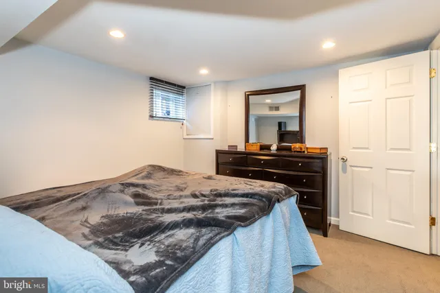 a bedroom with a bed and a dresser