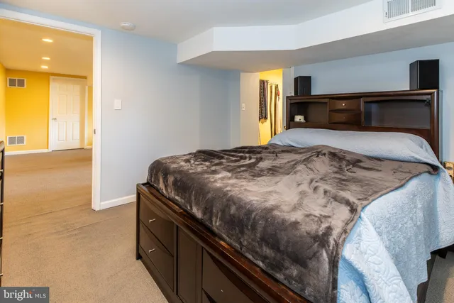 a bedroom with a bed and dresser