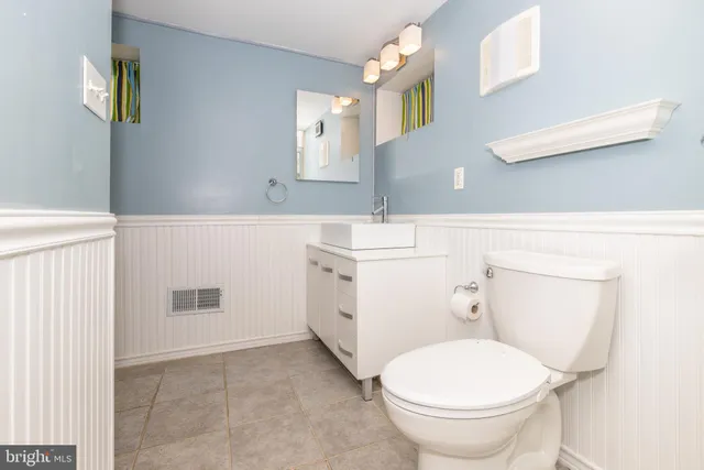 a bathroom with a sink toilet and mirror