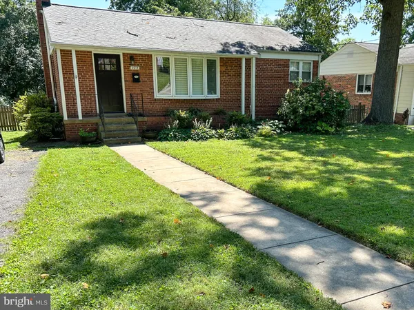a front view of a house with a yard and plants