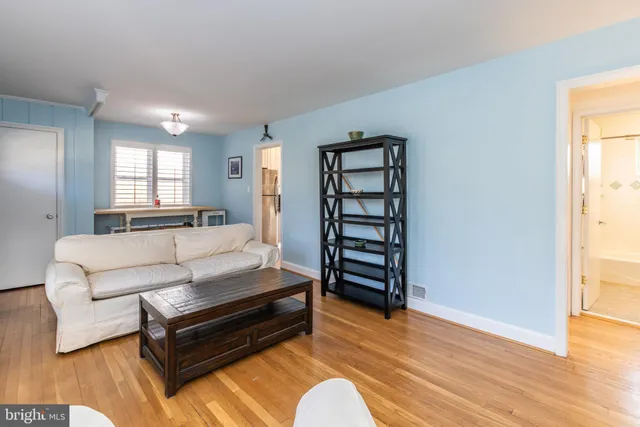 a bedroom with furniture and wooden floor