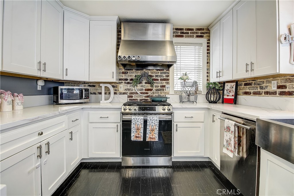 3533 Millhouse Court Riverside, CA 92503 - Photo 12 of 37 a kitchen with stainless steel appliances granite countertop a stove and white cabinets