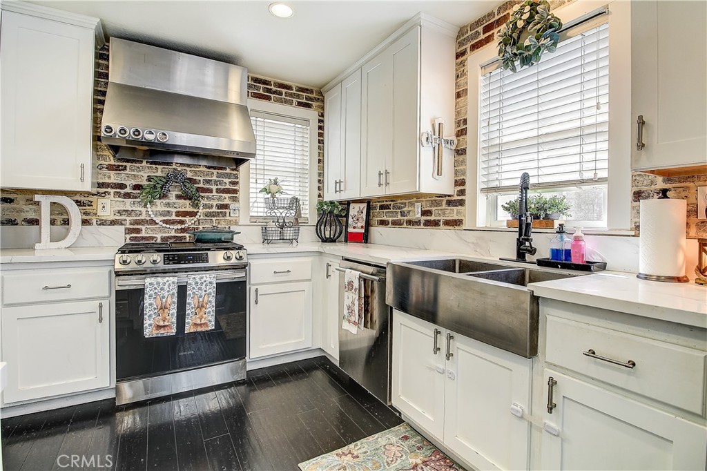 3533 Millhouse Court Riverside, CA 92503 - Photo 13 of 37 a kitchen with stainless steel appliances a stove a sink and white cabinets