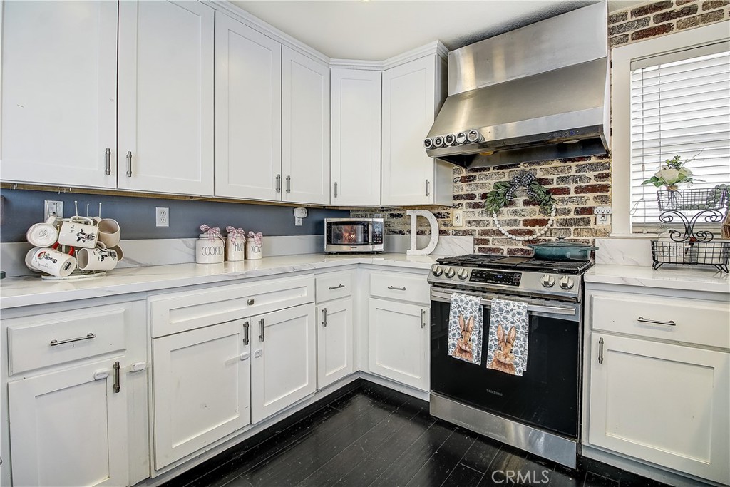 3533 Millhouse Court Riverside, CA 92503 - Photo 14 of 37 a kitchen with stainless steel appliances granite countertop white cabinets a sink and dishwasher