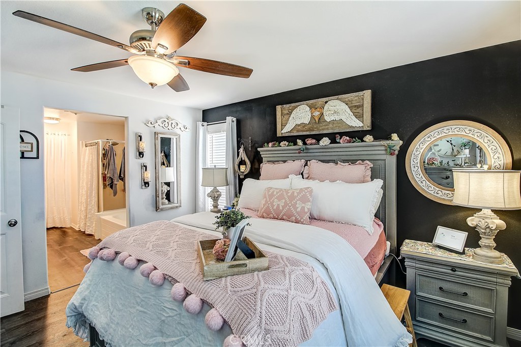 3533 Millhouse Court Riverside, CA 92503 - Photo 20 of 37 a bedroom with a bed and a chandelier