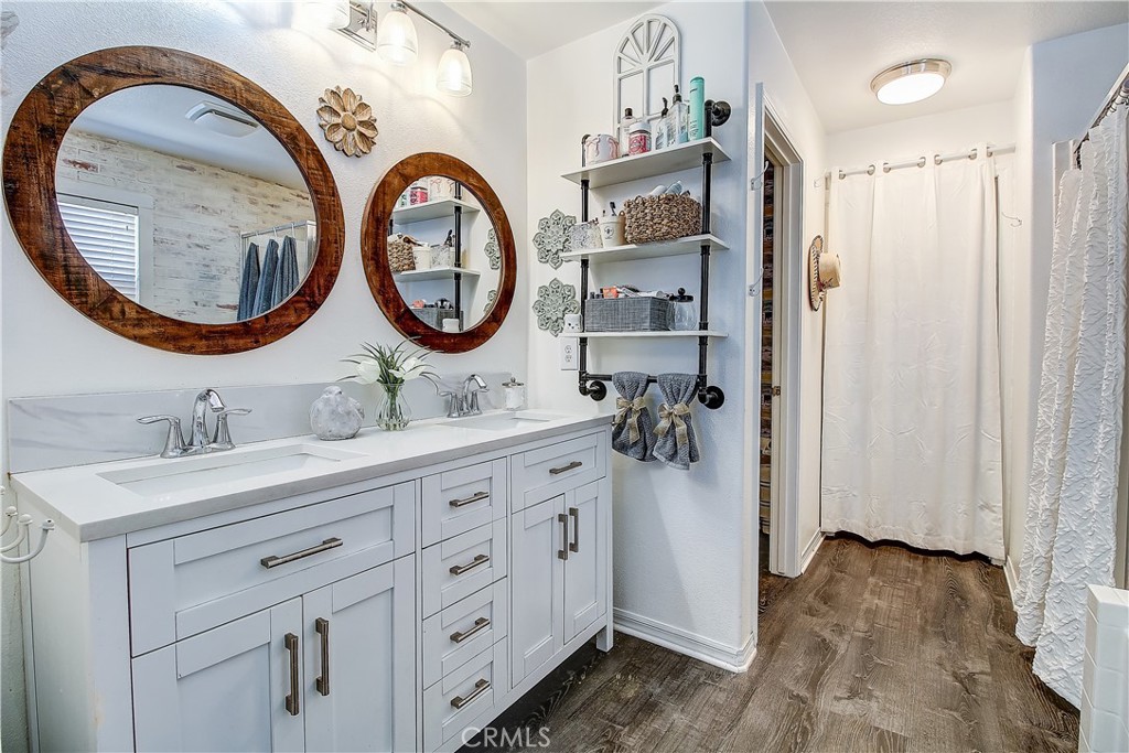 3533 Millhouse Court Riverside, CA 92503 - Photo 23 of 37 a bathroom with a granite countertop double vanity sink and mirror