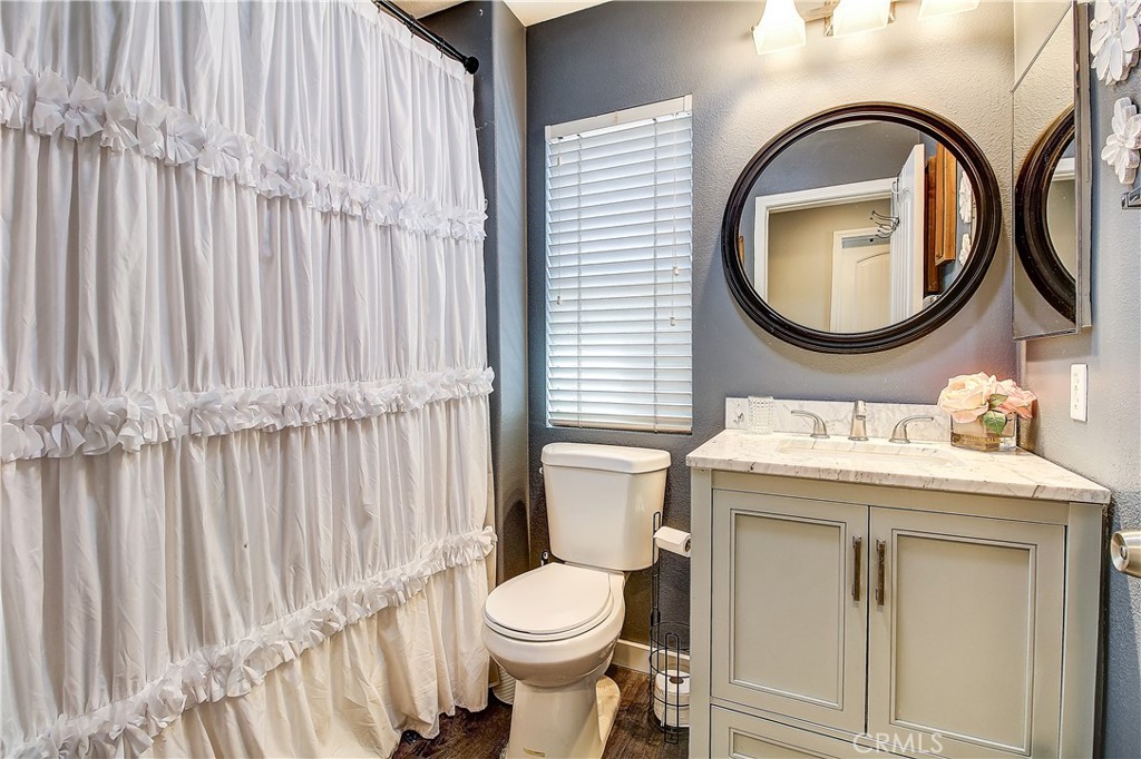 3533 Millhouse Court Riverside, CA 92503 - Photo 27 of 37 a bathroom with a toilet a sink and a mirror