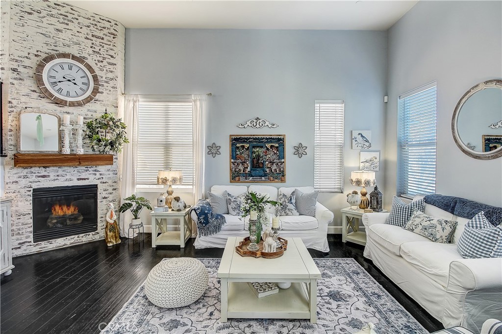 3533 Millhouse Court Riverside, CA 92503 - Photo 5 of 37 a living room with furniture a clock and a fireplace