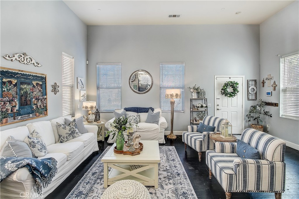 3533 Millhouse Court Riverside, CA 92503 - Photo 6 of 37 a living room with furniture a clock on wall and a window