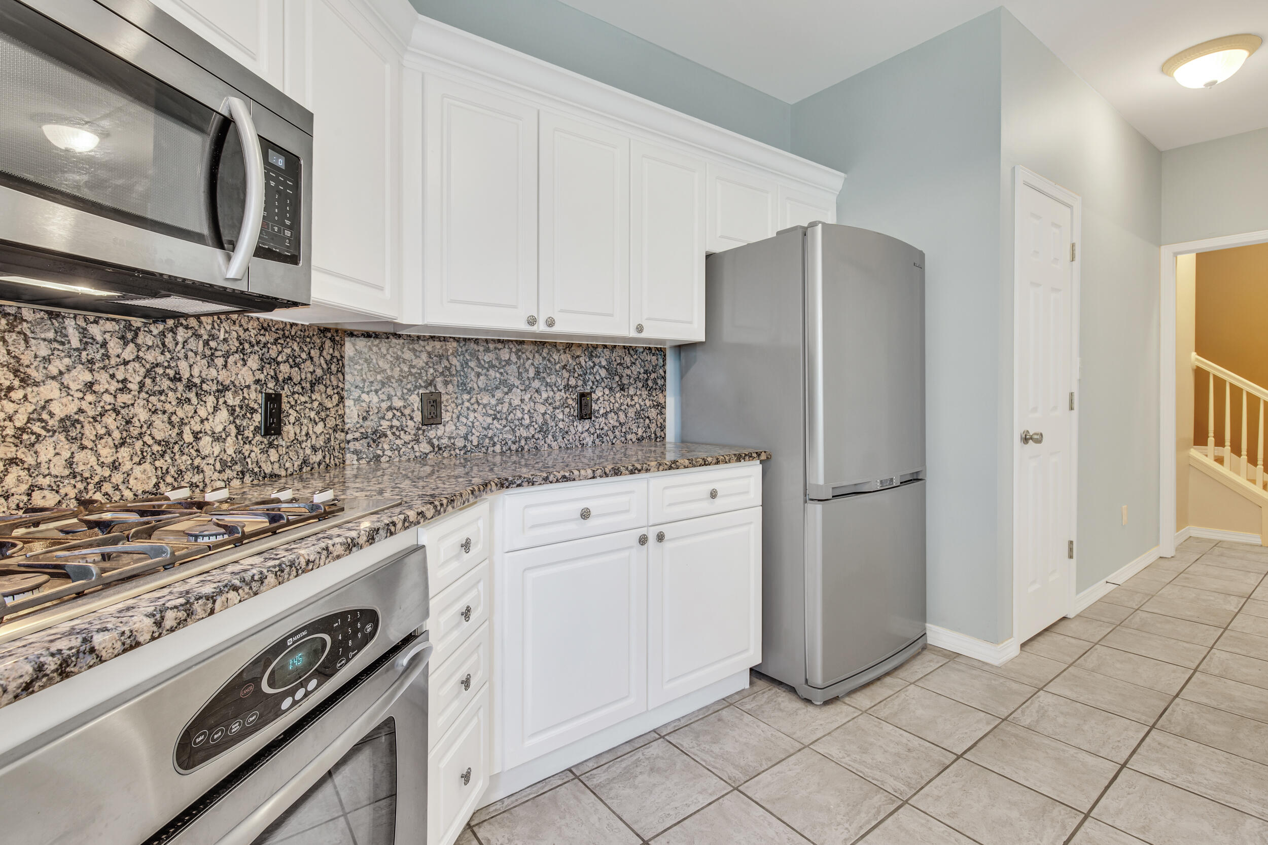 244 Indigo Loop Destin, FL 32550 - Photo 11 of 41 a kitchen with white cabinets and white appliances