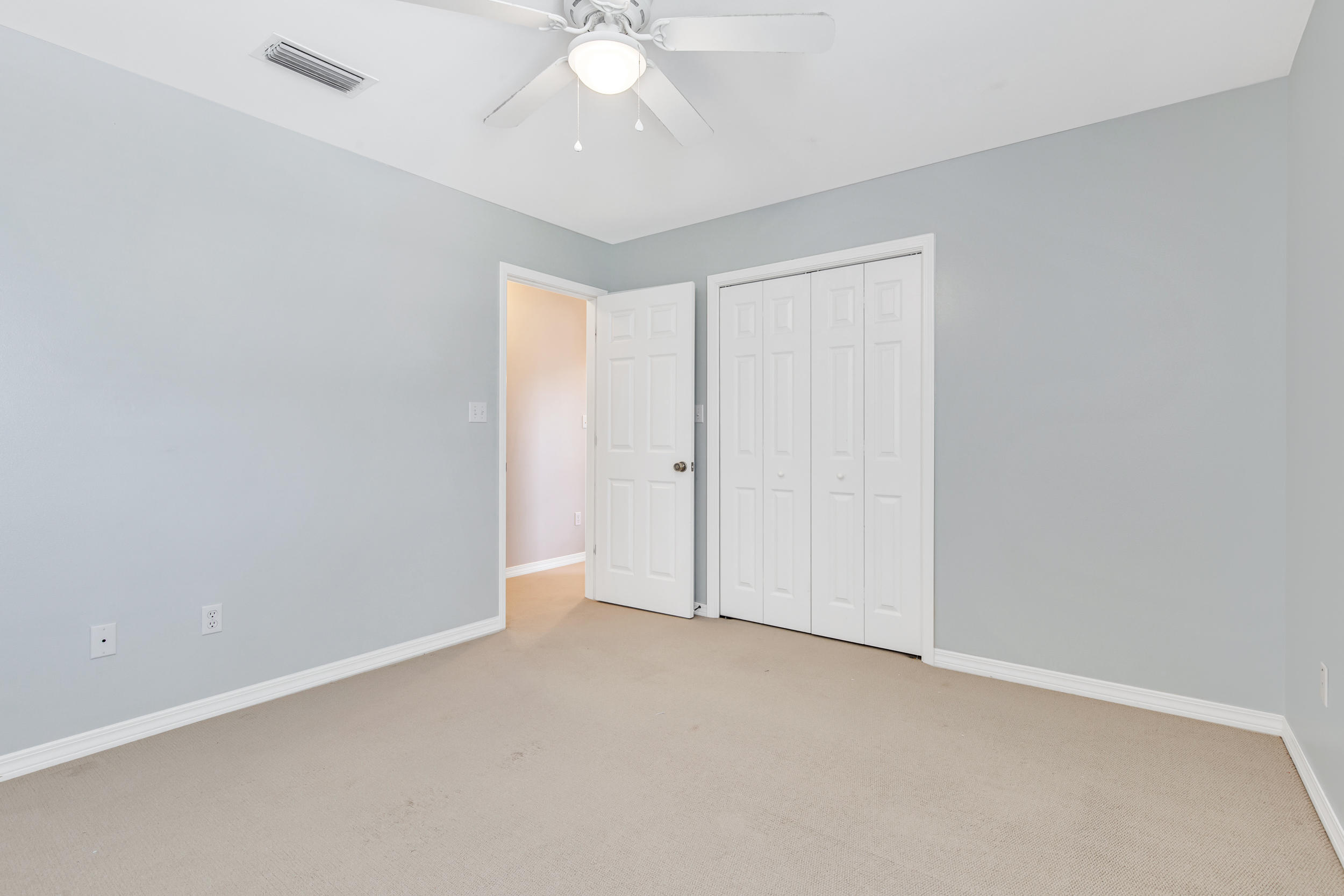244 Indigo Loop Destin, FL 32550 - Photo 20 of 41 an empty room with a ceiling fan and carpet