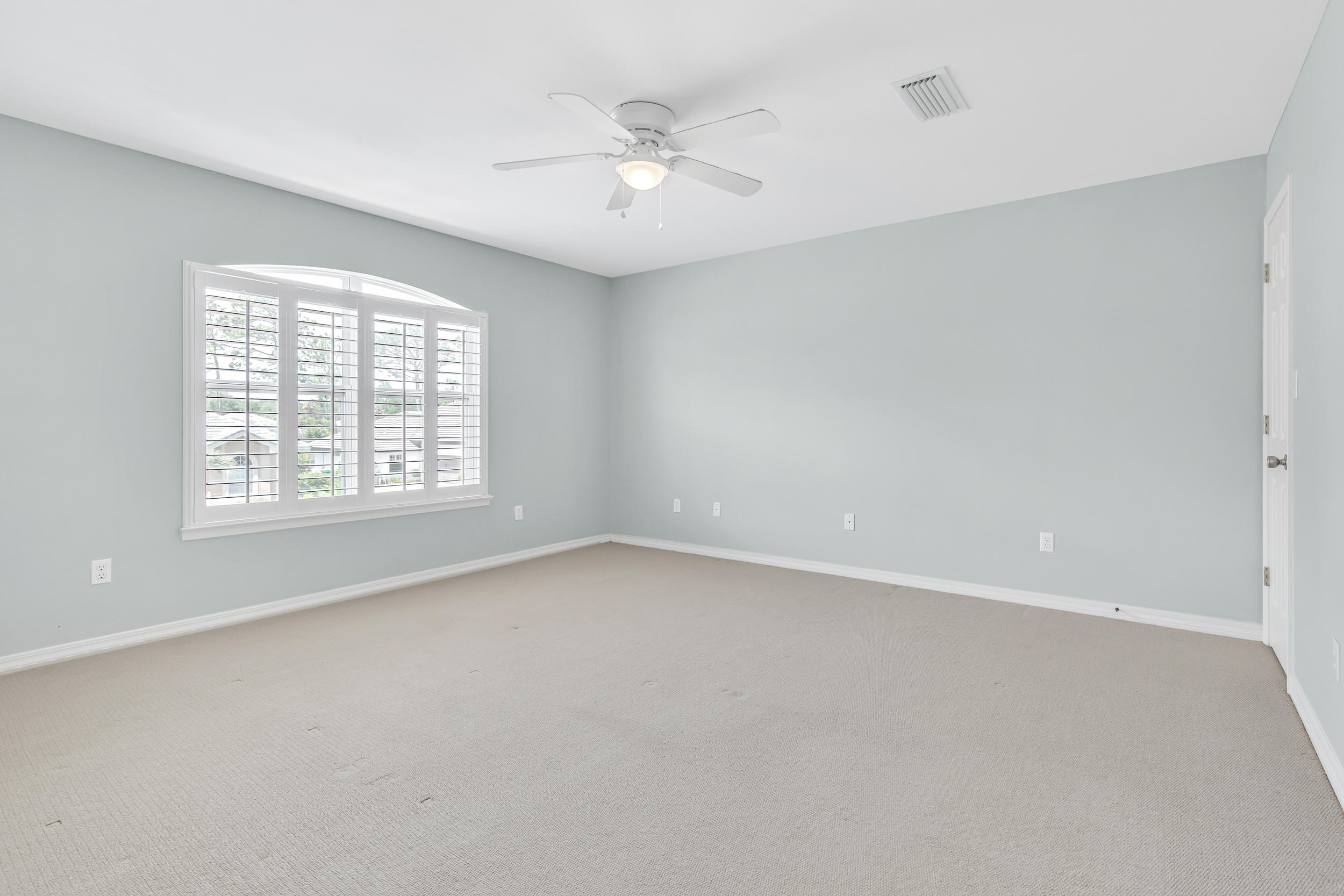 244 Indigo Loop Destin, FL 32550 - Photo 23 of 41 an empty room with windows and ceiling fan