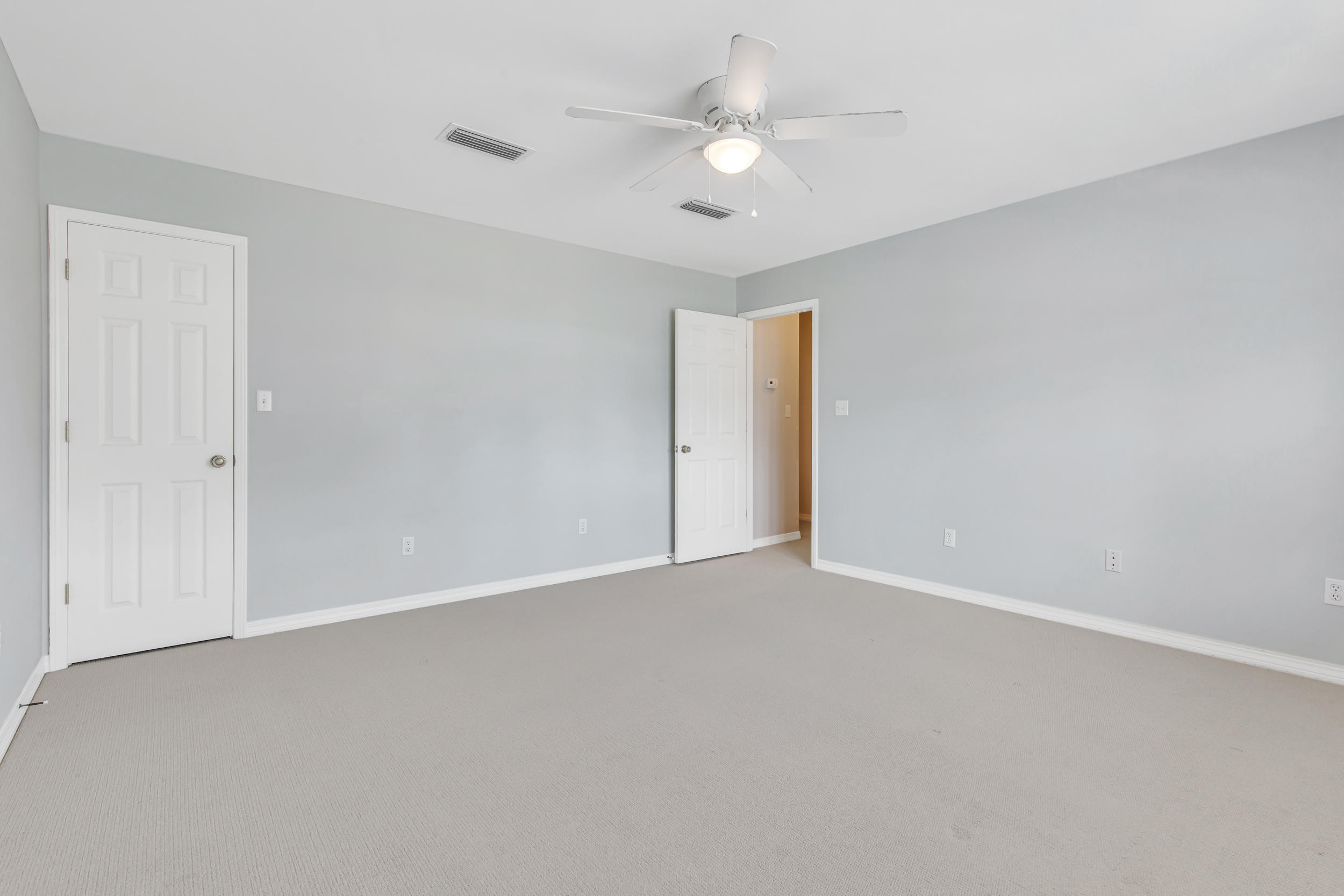 244 Indigo Loop Destin, FL 32550 - Photo 24 of 41 an empty room with a ceiling fan and a window