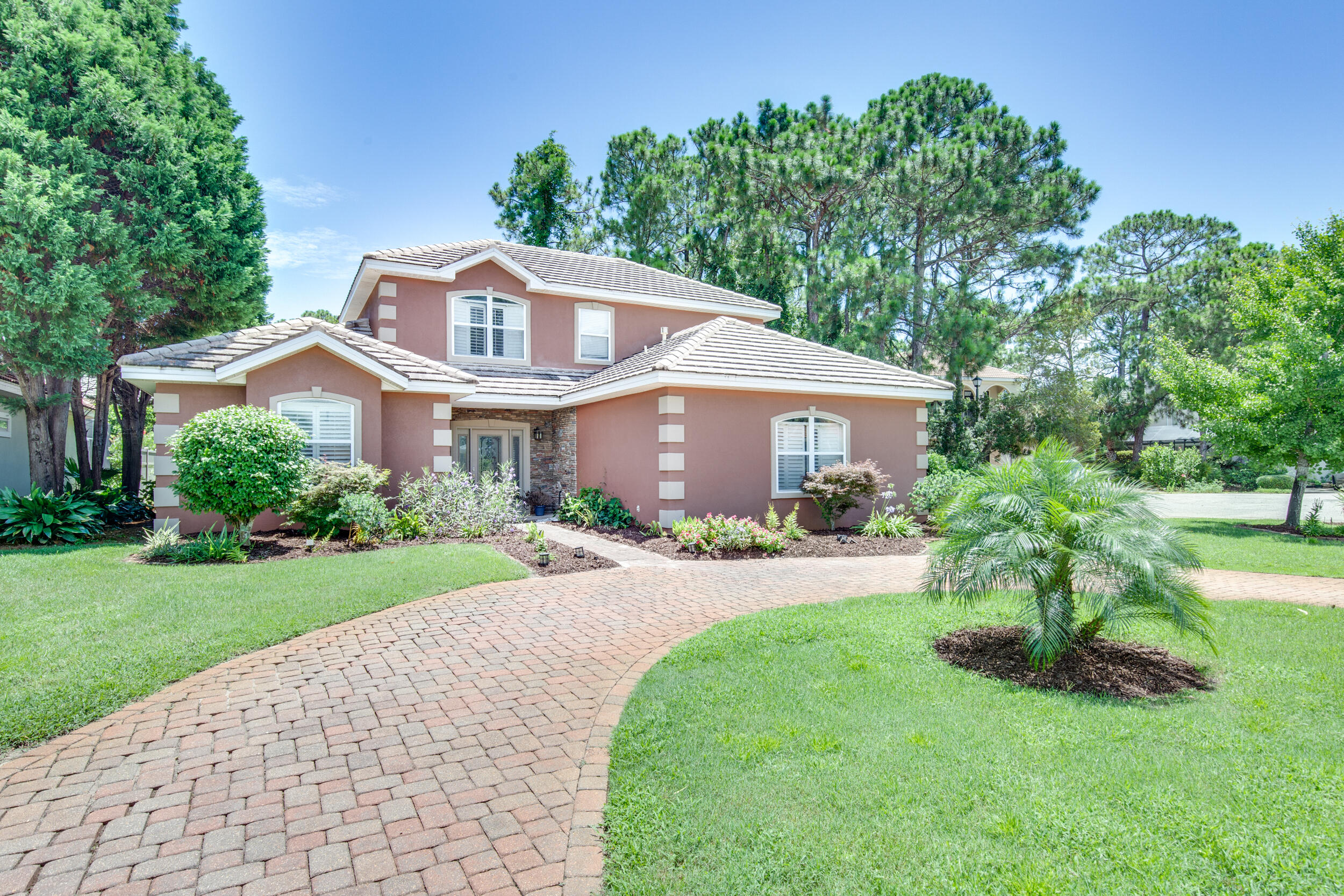 244 Indigo Loop Destin, FL 32550 - Photo 30 of 41 a front view of a house with a garden and plants
